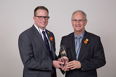 Rob Lister (right) and Peter Michaud (left) hold the award