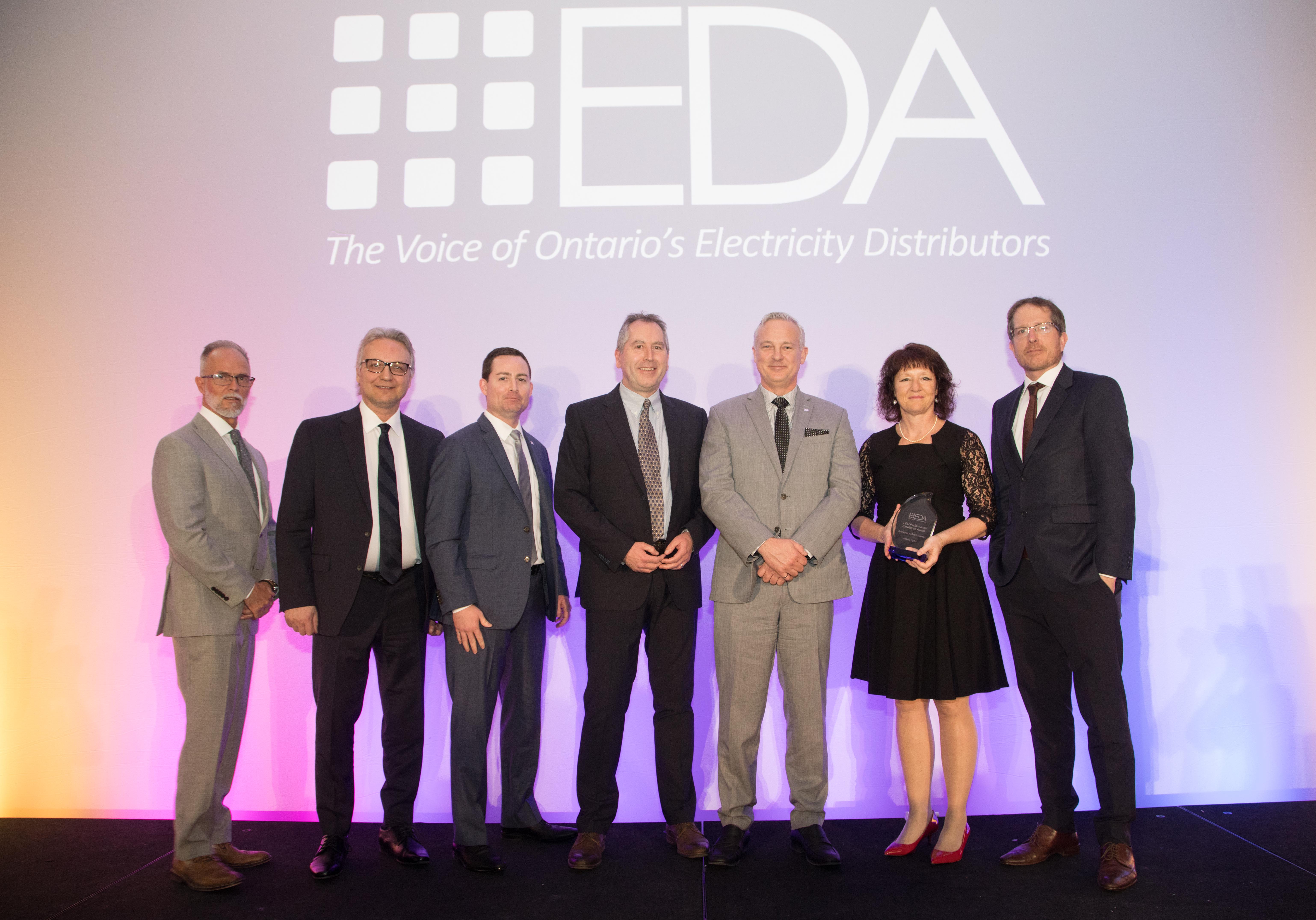 Members of the team stand on a stage and accept an award